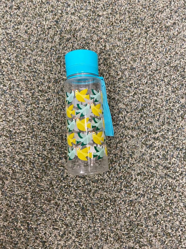 clear water bottle with yellow and blue birds images, blue lid and blue strap